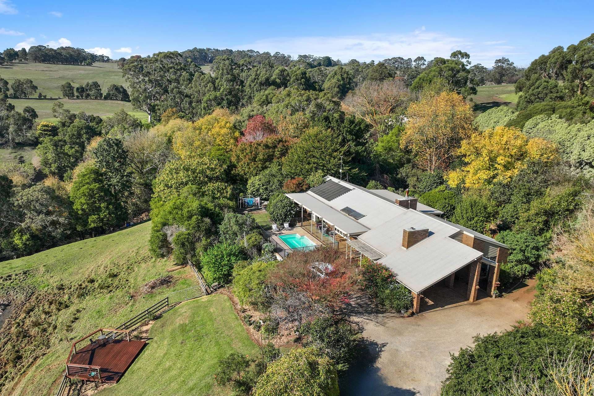 2130 Westernport Road, Ripplebrook — the homestead, pool and gardens from the air, with paddocks falling away to the north